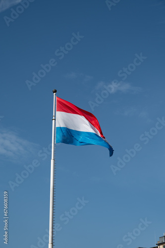 Views of flag of Luxembourg country and blue sky in Luxembourg or Luxembourg City capital city and one of de facto capitals of European Union