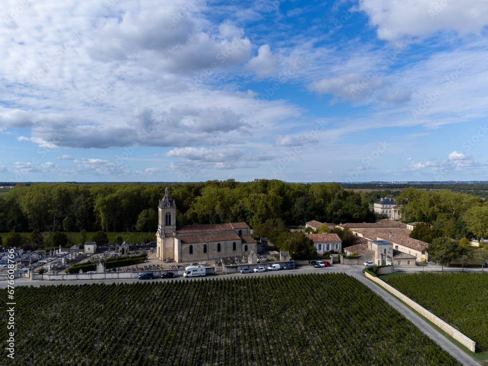 Aerial view on left bank of Gironde Estuary with green vineyards with red Cabernet Sauvignon grape variety of famous Haut-Medoc red wine making region, Bordeaux, France Aerial view on left bank of Gironde Estuary with green vineyards with red Cabernet Sauvignon grape variety of famous Haut-Medoc red wine making region, Bordeaux, France