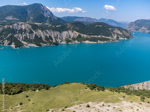 Aerial view on blue Lake of Serre-Poncon, reservoir border between Hautes-Alpes and Alpes-de-Haute Provence  departments, one of largest in Western Europe
