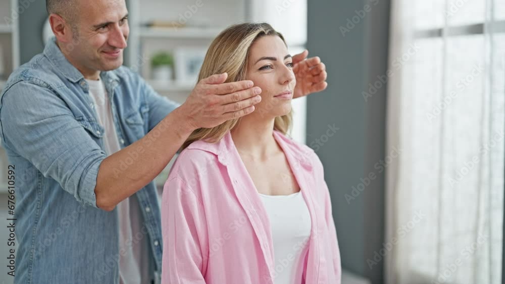 Man and woman couple hugging each other covering eyes for surprise at home Man and woman couple hugging each other covering eyes for surprise at home