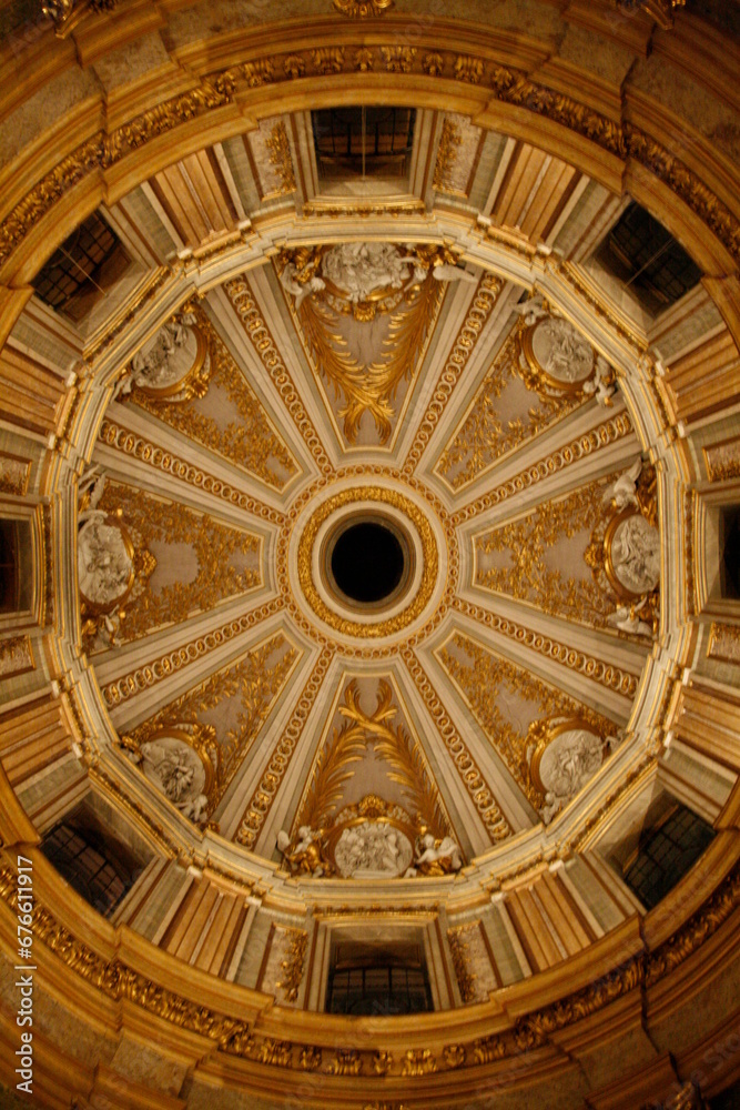 The ceiling of the building features an intricate and ornate dome
