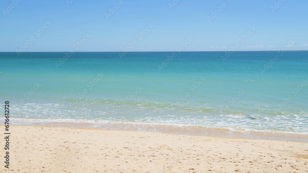 Waves crashing on the sandy beach