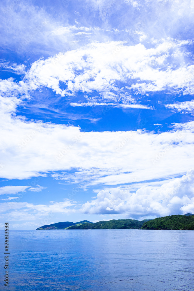 Tropical islands on a sunny, blue sky. Portrait. Romblon Island, Philippines