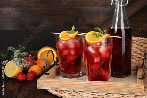 Delicious refreshing sangria, fresh fruits and berries on wooden table