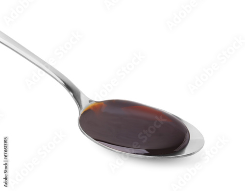 Spoon with delicious caramel syrup isolated on white
