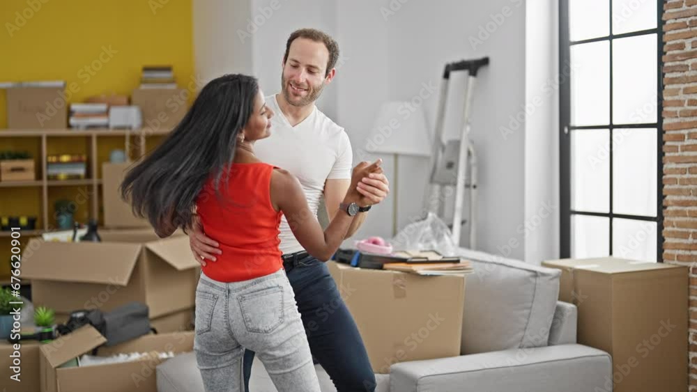 Beautiful couple standing together dancing at new home Beautiful couple standing together dancing at new home