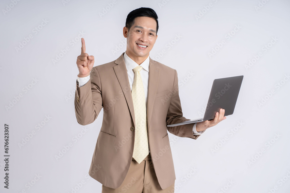 Image of Asian male businessman using laptop on white background Image of Asian male businessman using laptop on white background