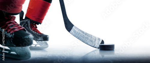 Hockey puck and stick close-up. Hockey player in ice rink. Focus on the puck. Hockey concept. Ice. Isolated photo