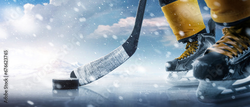 Hockey puck and stick close-up. Hockey player in ice rink. Focus on the puck. Hockey concept. Ice. Outdoor skating rink