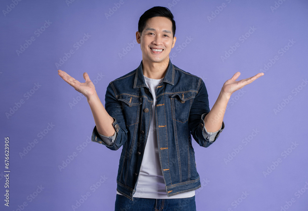 Image of Asian man posing on purple background Image of Asian man posing on purple background