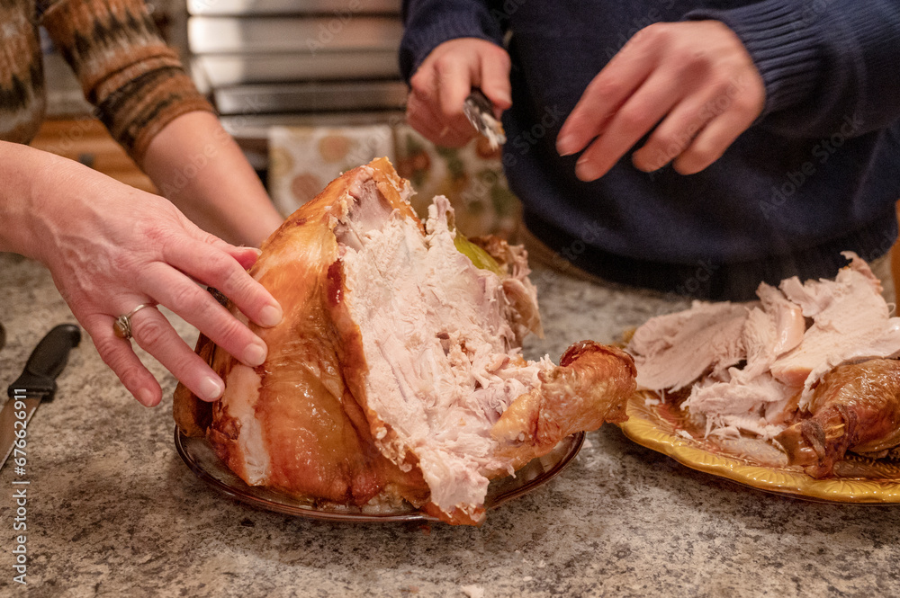 Thanksgiving traditional turkey preparation. Man cuts roasted turkey meat. Thanksgiving diner 