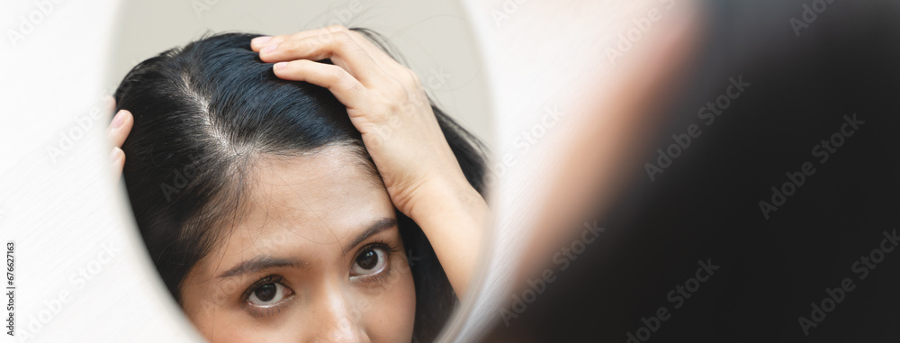 Fototapeta premium woman looking mirror to find hair problem