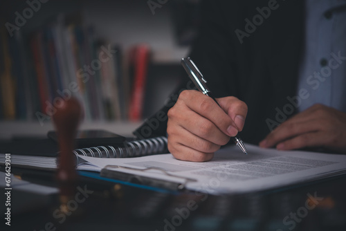 Business person Writing contract law and paper work for business and finance, write document, complete job application forms, contract real estate and insurance concept.