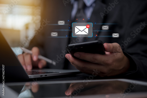 Businessman holding mobile phone icon email send digital technology marketing message communications and invite contact online electronic newsletter.. photo