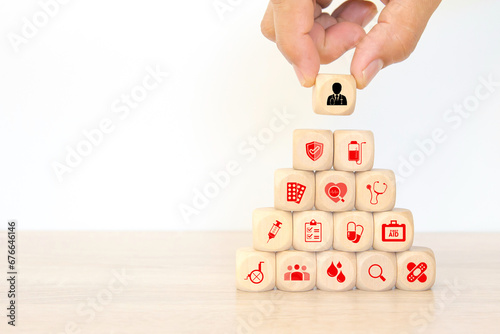 Hand chooses doctor on medical care on cube wooden block stack pyramid concept of safety insurance for sick illness wellbeing protection plan or retirement healthy therapy treatment or health checkup