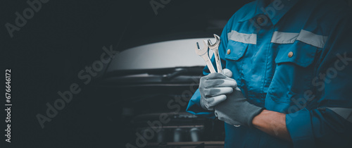 Car care maintenance and servicing, Hand technician auto mechanic using the wrench to fix car or repairing change spare part engine problem and insurance service support the range of car check. photo