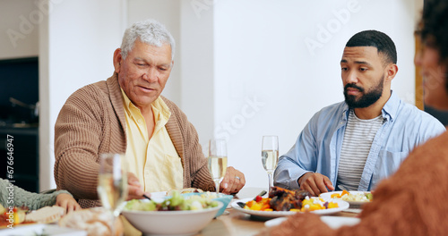 Food  holidays and a family at the dinner table of their home together for eating a celebration meal. Love  thanksgiving and a group of people in an apartment for festive health  diet or nutrition