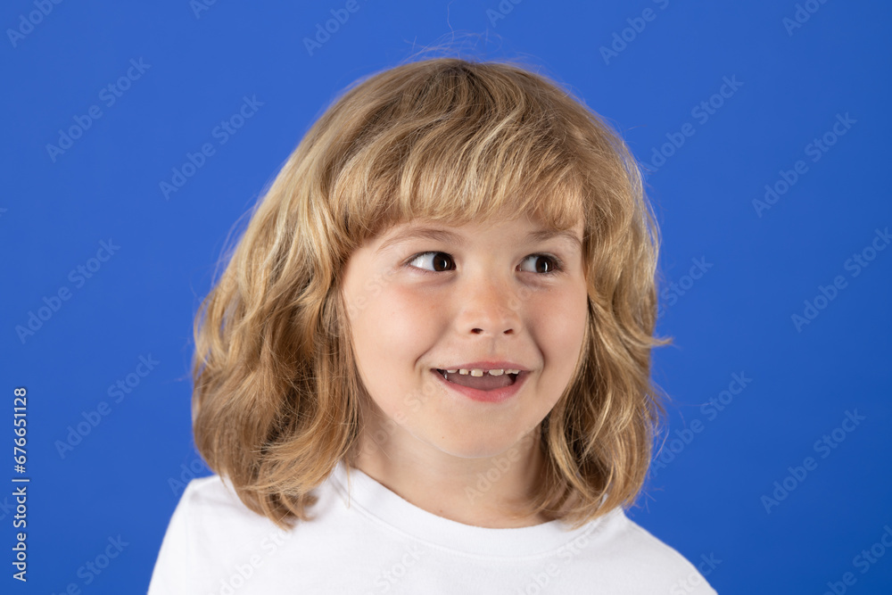 Studio portrait of cute kid looking away on blue isolated background. Studio portrait of cute kid looking away on blue isolated background.