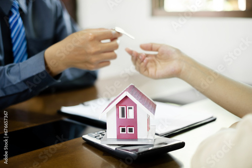 Wallpaper Mural Real estate agent broker hand over the house key to the new owner after completing the signing according to agreement renting a house and buy house insurance officially completed Torontodigital.ca