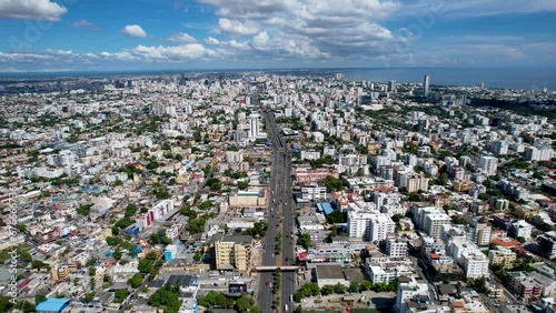 Aerial cinematic footage of the city of Santo Domingo, Capital Of Dominican Republic, its beautiful streets and buildings, la Fuente Centro de los Heroes, the Pabellón de las Naciones