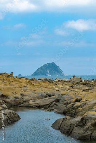 The landscape of the coastal rock at Heping Island Park in Keelung City, Taiwan, Keelung Islet is just in the back. photo