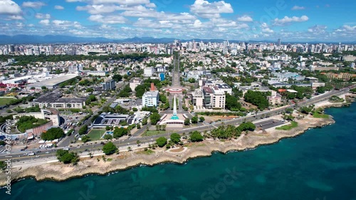 Aerial cinematic footage of the city of Santo Domingo, Capital Of Dominican Republic, its beautiful streets and buildings, la Fuente Centro de los Heroes, the Pabellón de las Naciones