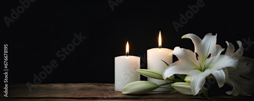 White candle. Eternal elegance. Delicate lily blossom in dark contrast. Botanical harmony. Blooming in composition of beauty. Spring serenity. Bright flower in nature embrace