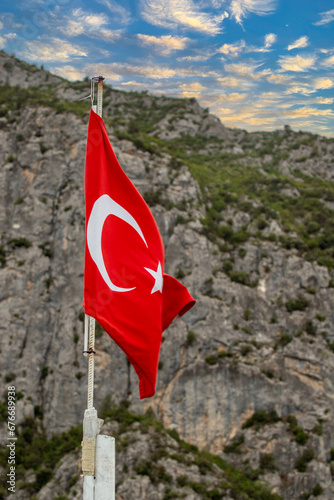 Photography Turkish flag. Turkish flag waving in front of rocky background
