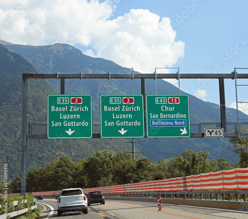 road signs on the motorway with directions to many locations in Switzerland photo