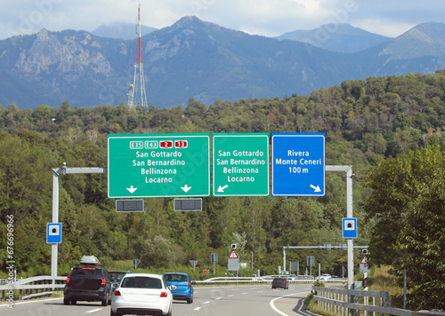 road signs on the motorway with directions to many locations in Switzerland near the Italian border photo