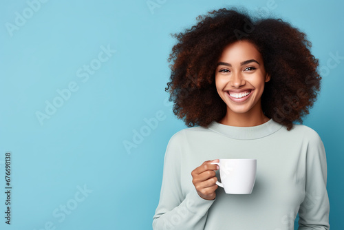 Happy African American woman with cup of coffee on blue background photo