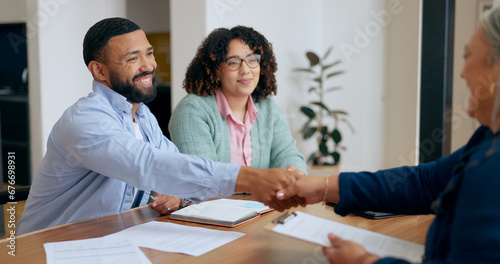 Couple, handshake and lawyer with documents for real estate, property investment or loan application with smile. People, man and woman with advisor, paperwork and shaking hands for legal deal or will photo