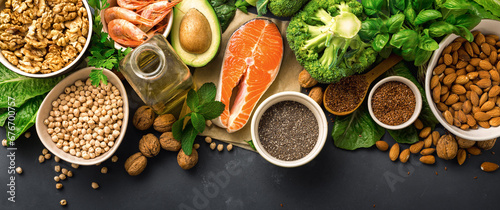 Fototapeta Naklejka Na Ścianę i Meble -  Food sources of omega 3 on dark background with copy space top view. Foods high in fatty acids including vegetables, seafood, nut and seeds. Health food fitness