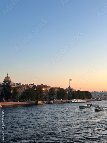 Sunset at the city river, riverside in the city © Oksana