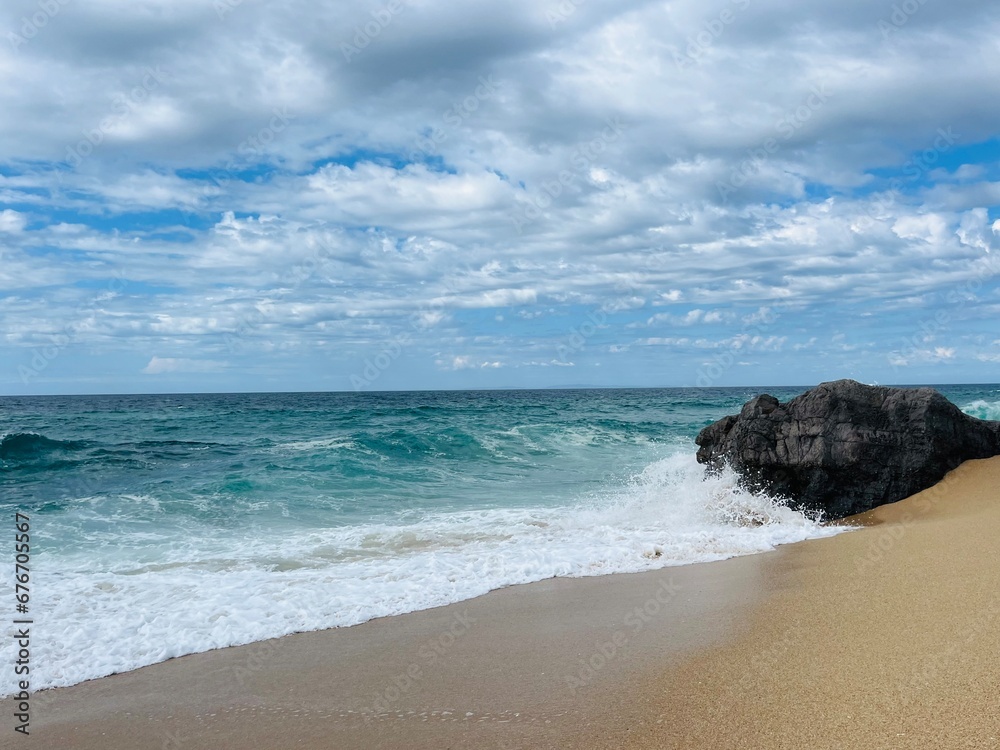 Waved ocean horizon, ocean coastline, sandy shore, splash and foam, cloudy sky, windy Waved ocean horizon, ocean coastline, sandy shore, splash and foam, cloudy sky, windy