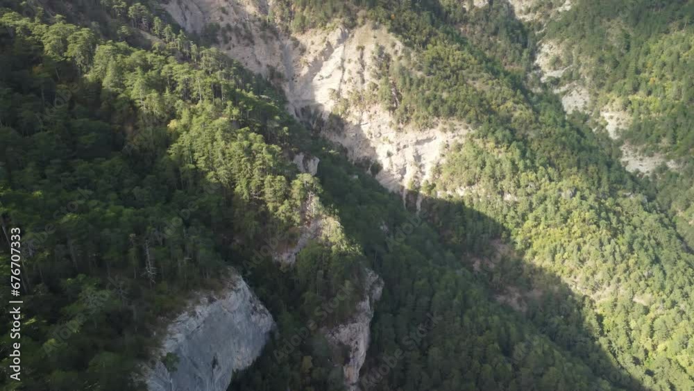 Aerial panoramic view of forest on rocky mountain slope - Ai Petri, Yalta, Crimea. Abstract aerial nature forest and mountains. Weather and Climate Change. Vacation, travel and holiday concept Aerial panoramic view of forest on rocky mountain slope - Ai Petri, Yalta, Crimea. Abstract aerial nature forest and mountains. Weather and Climate Change. Vacation, travel and holiday concept
