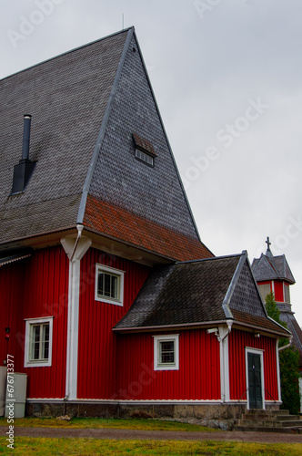 Red wooden church build in 1693. The church is located in the church village of Iiti, Finland. Church has a high and pointed Dutch hip roof, sometimes called a Dutch gable roof. © Katja Kerminen