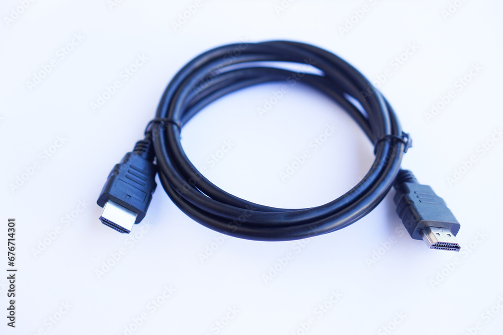 Black HDMI connector cable on white background. Equipment for transmitting digital video and audio from computer to a monitor, projector or TV screen. Concept, technology electronic device Black HDMI connector cable on white background. Equipment for transmitting digital video and audio from computer to a monitor, projector or TV screen. Concept, technology electronic device