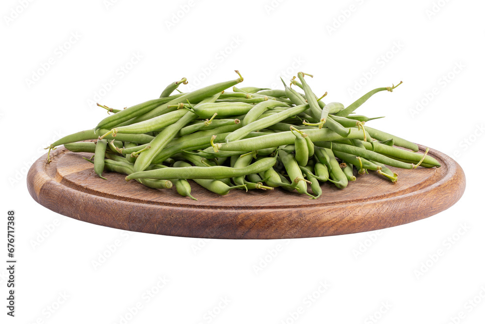 Green beans on a round cutting board isolated on a white background. Healthy vegetables. Green beans on a round cutting board isolated on a white background. Healthy vegetables.