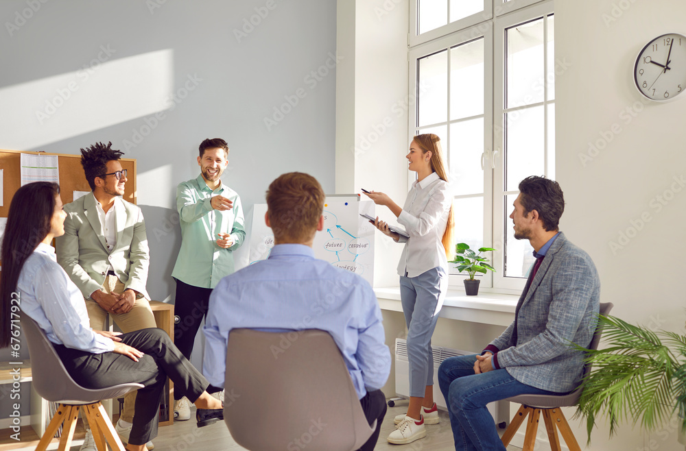 Male and female business coaches giving presentation in office. Speakers or presenters consulting, training group of employees, explaining graph strategy at meeting workshop