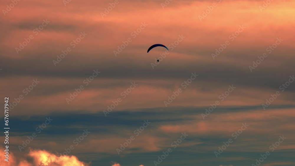 Aerial View over a Paraglider Flying and with Beautiful Orange Clouds with Sunlight in Ticino, Switzerland. Aerial View over a Paraglider Flying and with Beautiful Orange Clouds with Sunlight in Ticino, Switzerland.