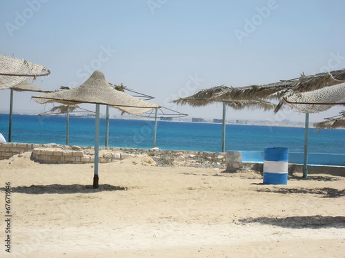 beach with umbrellas and chairs and clear sky 