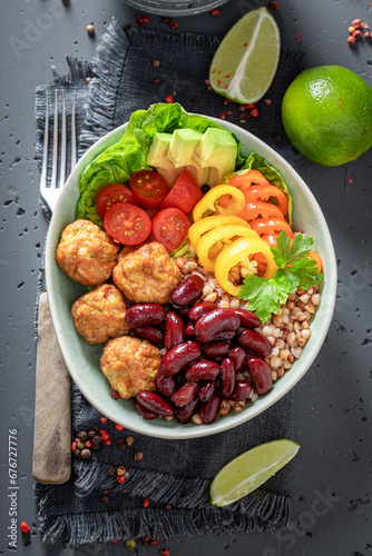 Spicy Mexican salad with meatballs, beans, groats and pepper.