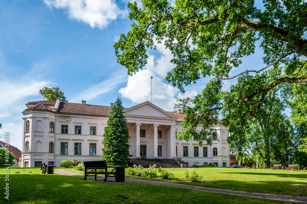 Obraz premium Ivande manor in sunny summer day, Latvia. Courtyard view.