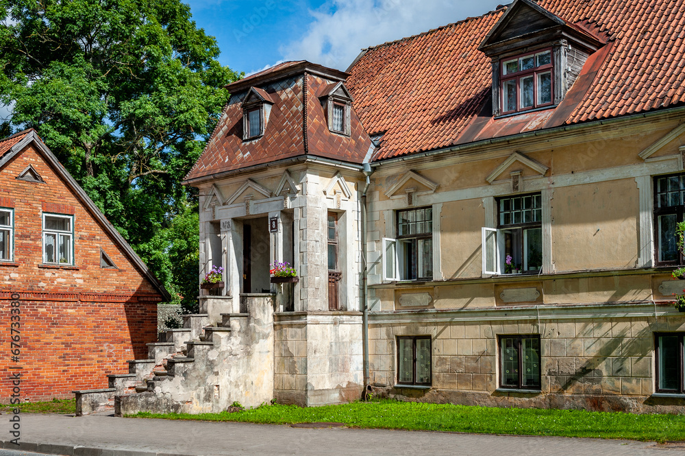 View of the street in Kuldiga with old house and stone road. Latvia. Kuldiga is included in the UNESCO World Heritage List.