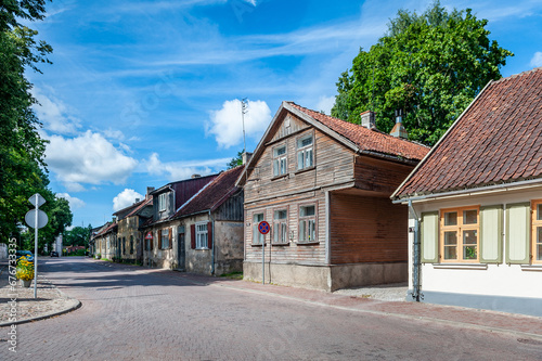 View of the street in Kuldiga with old wooden house and stone road. An example of wooden architecture from the 18th century. Latvia. © Regina