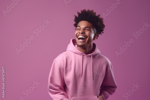 portrait of a black african man in a hoodie laughing against a studio background with copy space, generative ai © inna717