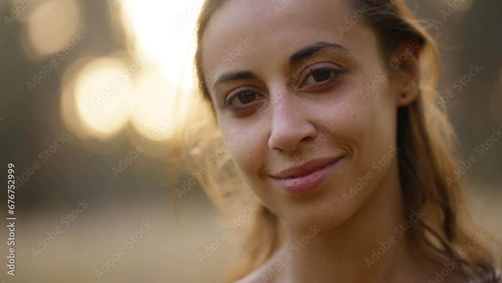 Beautiful Smiling Young brunette Woman wearing yellow sundress with perfect tanned Skin relaxing in forest. Happy girl walking in park. Portrait of cheerful stylish girl in dress looking at camera Beautiful Smiling Young brunette Woman wearing yellow sundress with perfect tanned Skin relaxing in forest. Happy girl walking in park. Portrait of cheerful stylish girl in dress looking at camera