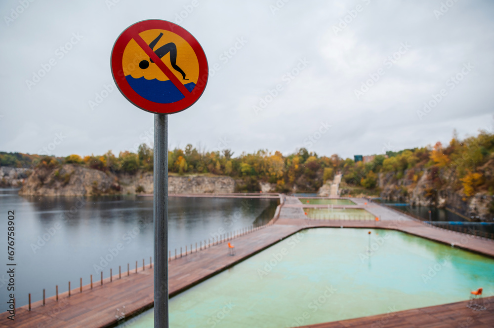No swimming sign on the bank of the Zakrzowek quarry in Krakow