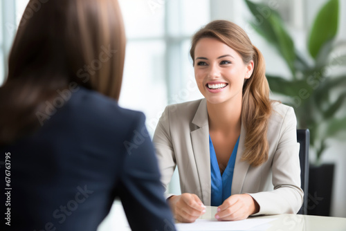 A business woman in a job interview smiling at her interviewer. © PixelGallery